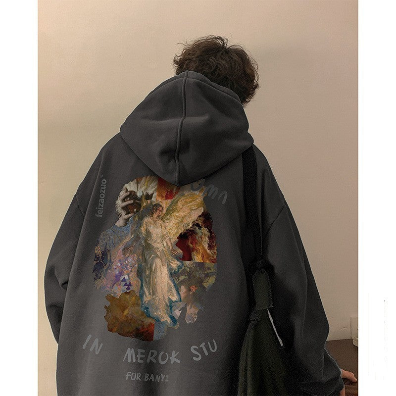 Person wearing a dark hoodie with a colorful graphic and text on the back against a plain wall.