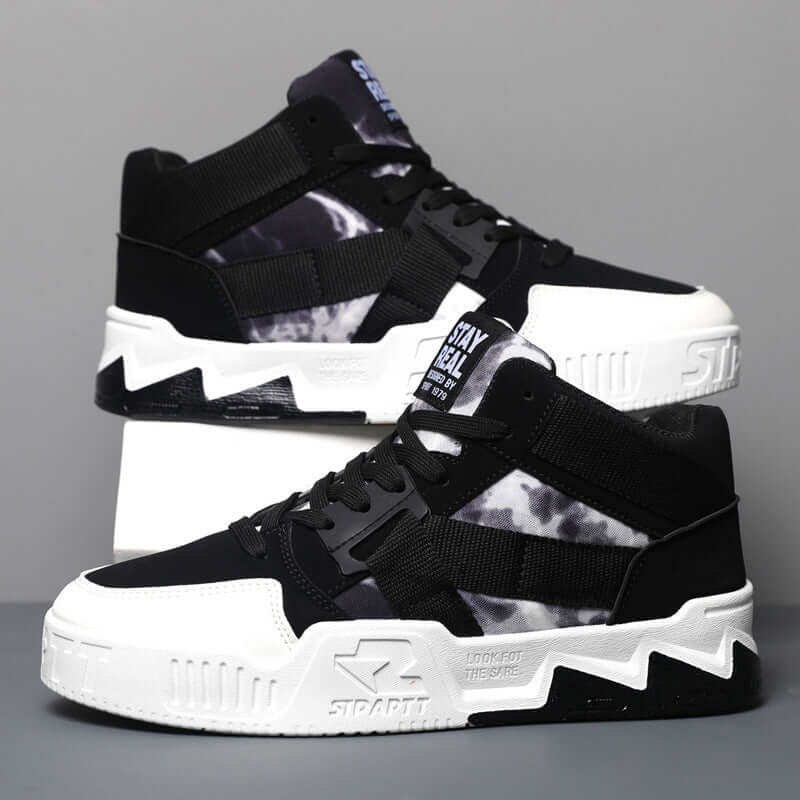 Black and white sneakers with a gray background