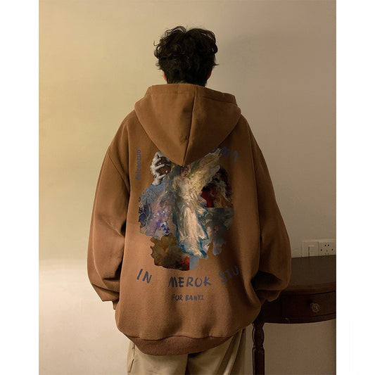 Person wearing a brown hoodie with a colorful design on the back, standing against a plain wall.