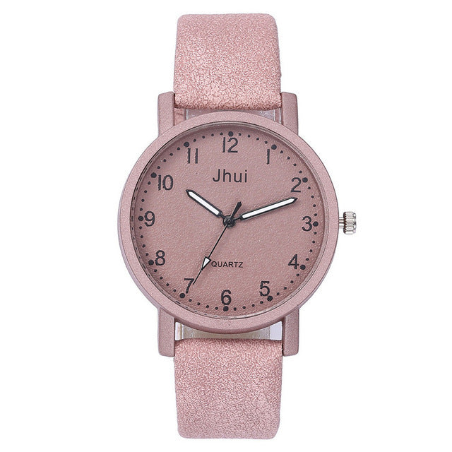 Pink watch with a glittery strap on a white background