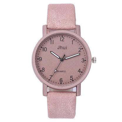 Pink watch with a glittery strap on a white background