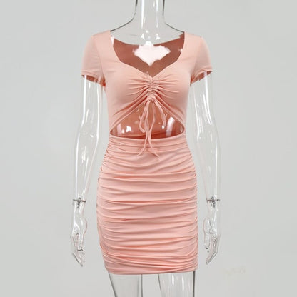 Pink ruched dress on a mannequin against a gray background