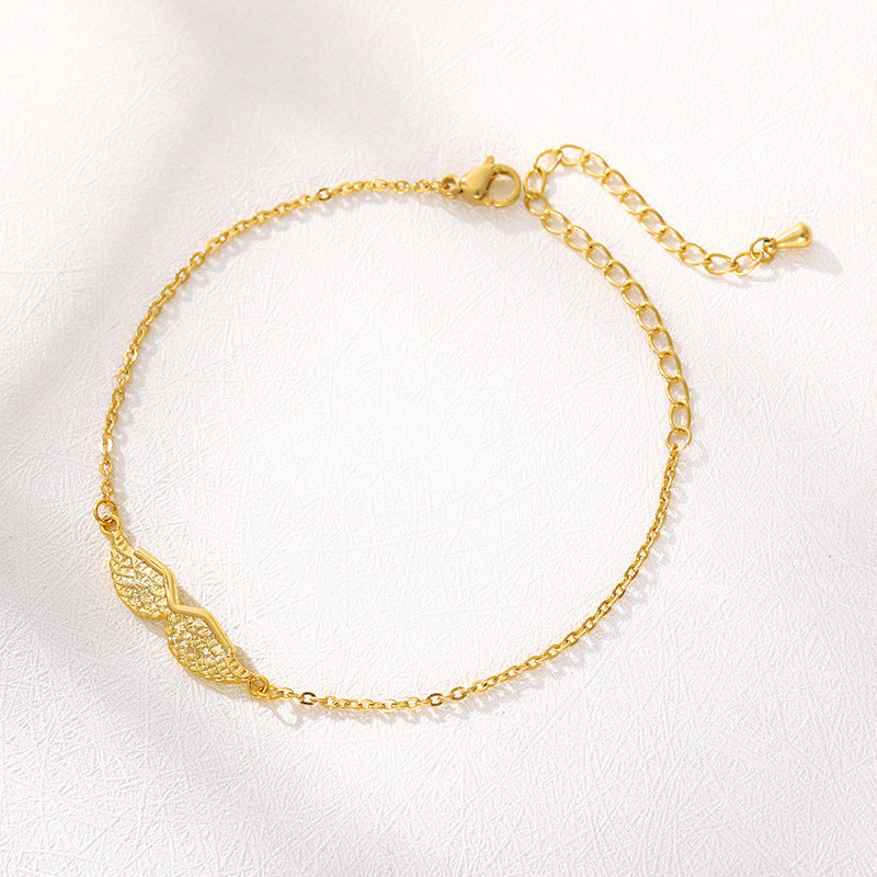 Gold bracelet with intricate design on a white background