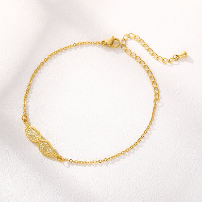 Gold bracelet with intricate design on a white background