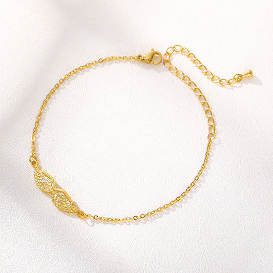 Gold bracelet with intricate design on a white background