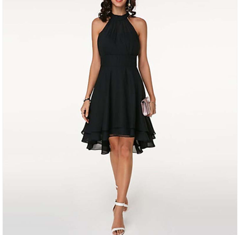 Black halter neck dress worn by a model on a white background