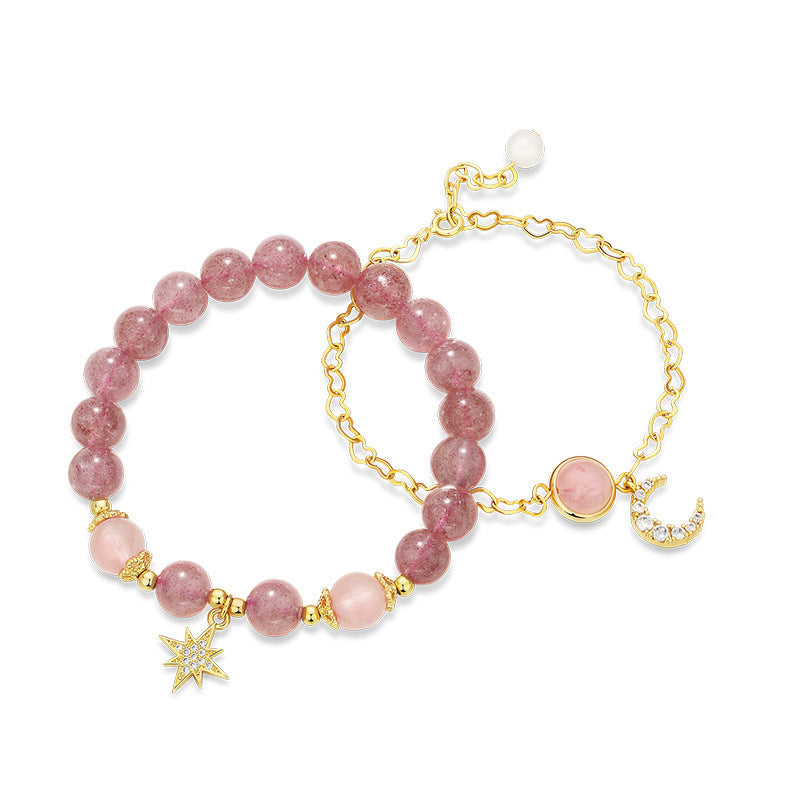 Pink beaded bracelet with gold accents on a white background