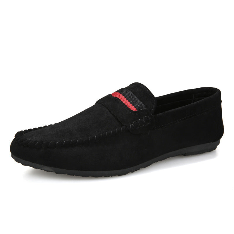 Black loafer shoe with a red accent on a white background