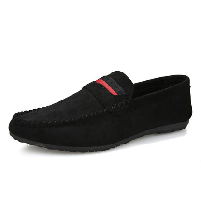 Black loafer shoe with a red accent on a white background