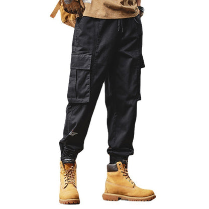 Black cargo pants with beige boots on a white background