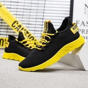 Black and yellow sneakers with 'WARNING' text on a light gray background