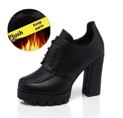 Black high-heeled shoes with plush lining feature on a white background