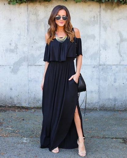 Woman wearing a black off-shoulder dress with a gray wall background