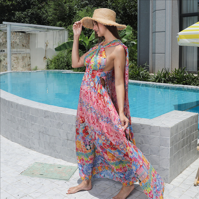 Woman in a colorful dress and hat by a pool