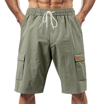 Green cargo shorts with a drawstring on a white background