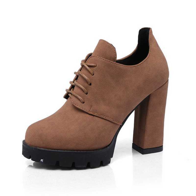 Brown suede shoe with a block heel on a white background