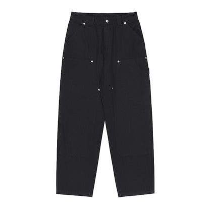 Black pants with button details on a white background