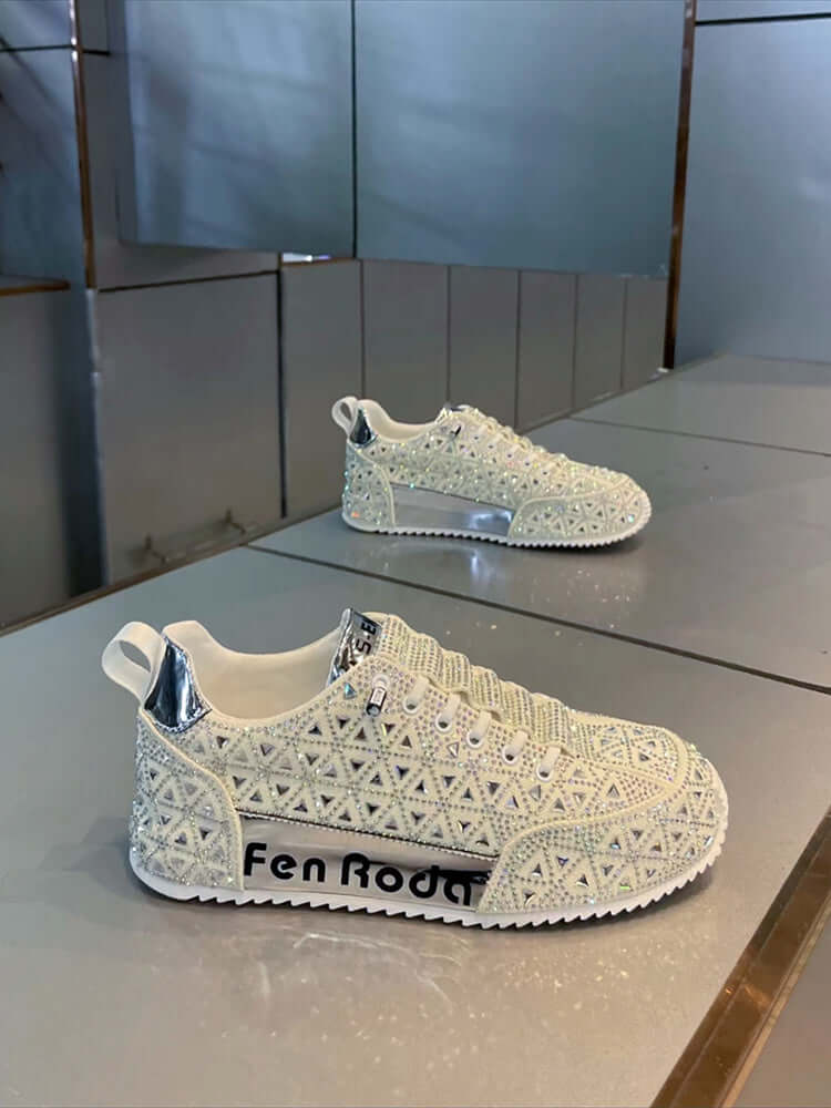 White embellished sneakers with 'Fen Rodo' branding on a reflective surface.