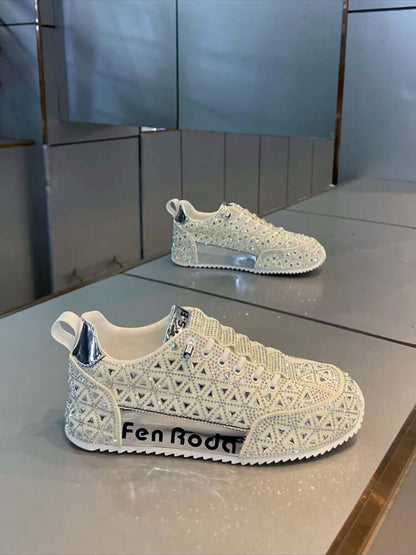 White embellished sneakers with 'Fen Rodo' branding on a reflective surface.