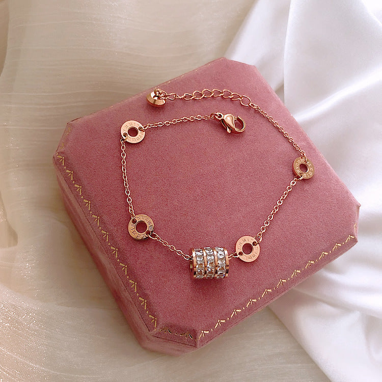 Rose gold bracelet on a pink jewelry box with a soft white background