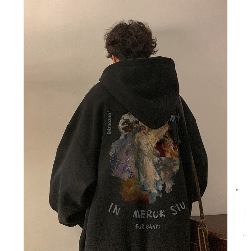 Person wearing a black hoodie with a colorful design on the back, standing indoors.