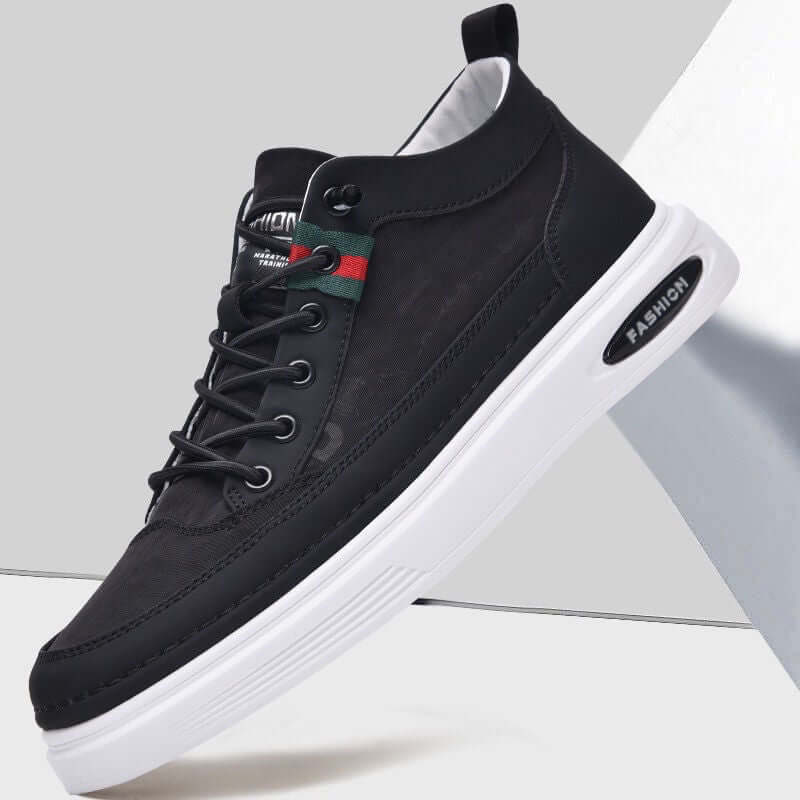 Black sneaker with white sole on a light gray background