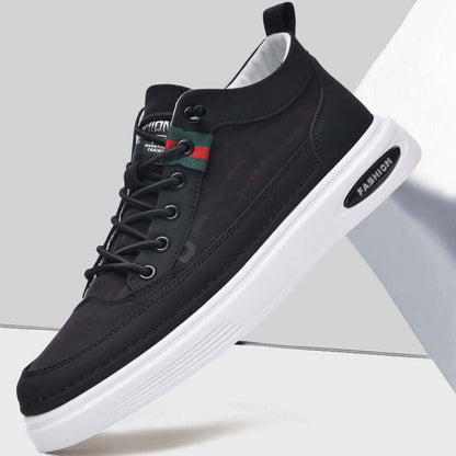 Black sneaker with white sole on a light gray background