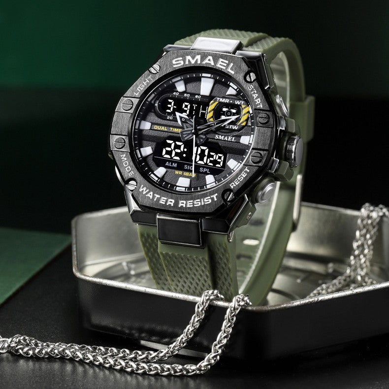 Digital watch with green strap and black casing on a reflective surface
