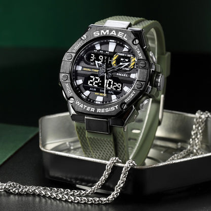 Digital watch with green strap and black casing on a reflective surface
