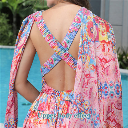 Colorful floral dress with open back worn by a person, poolside.