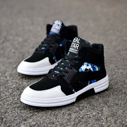 Black and white high-top sneakers with blue accents on a gray pavement background