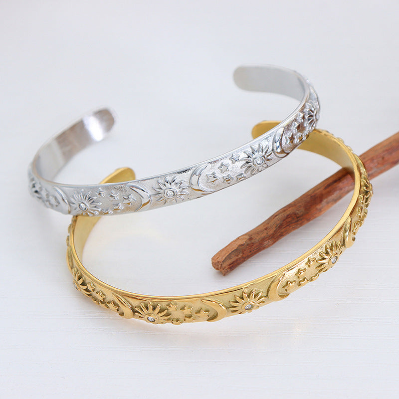 Gold and silver bangles with intricate designs on a white background