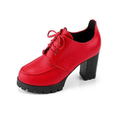 Red shoe with a black sole on a white background