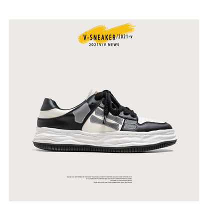 Black and white sneaker with gray accents on a white background, featuring 'V-SNEAKER/2021-V' text.