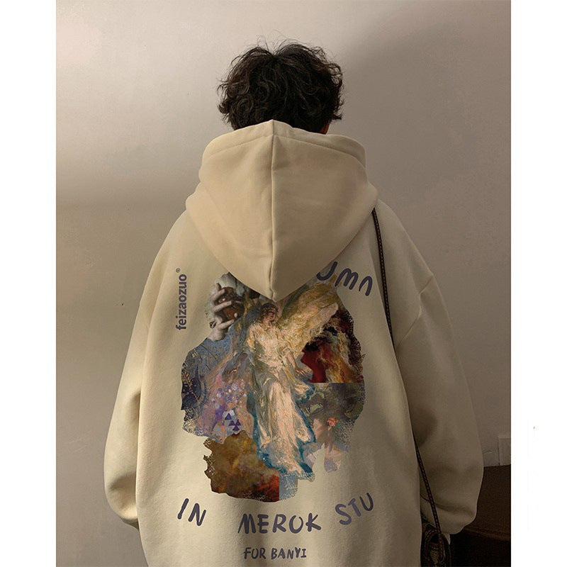 Person wearing a beige hoodie with artistic design and text on the back.