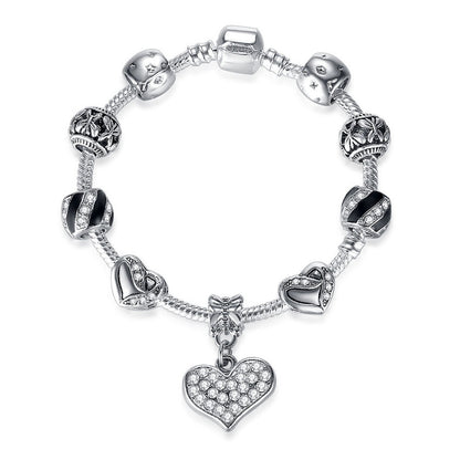 Silver bracelet with heart charm on a white background