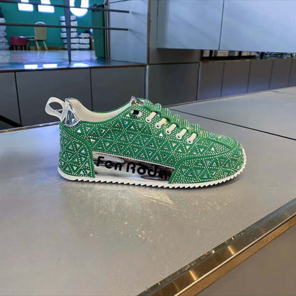 Green sneaker with rhinestone pattern on a metallic surface