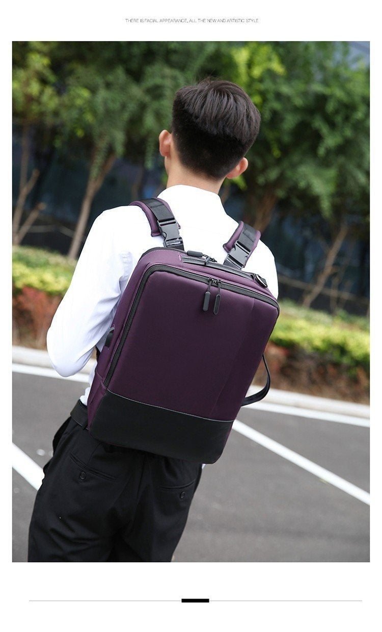Person wearing a purple backpack outdoors on a road with greenery.
