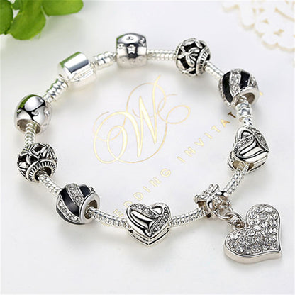 Silver bracelet with heart-shaped charms on a white background