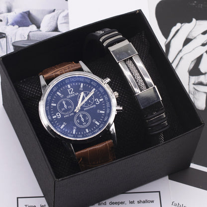 Watch and bracelet set in a black box with a blue dial watch on a white background