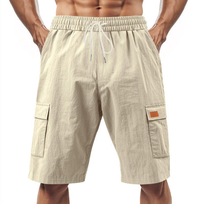 Beige cargo shorts with a drawstring on a white background