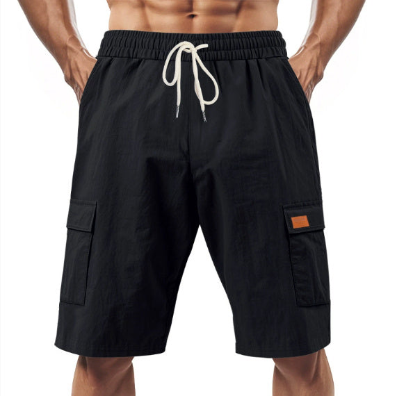 Black cargo shorts with a drawstring on a white background