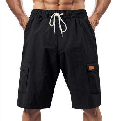 Black cargo shorts with a drawstring on a white background