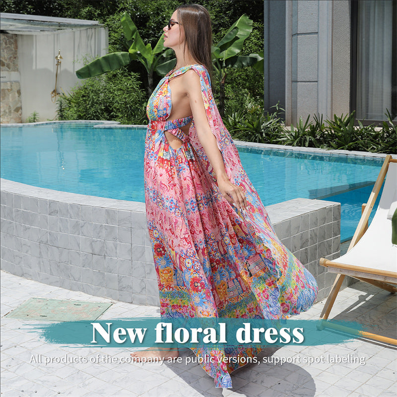 Woman in a colorful floral dress standing by a poolside