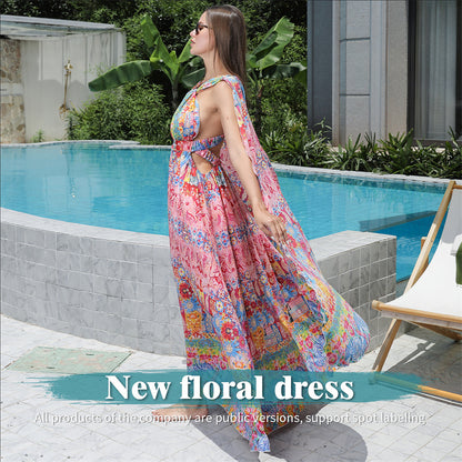 Woman in a colorful floral dress standing by a poolside