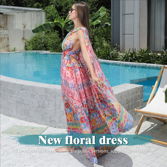 Woman in a colorful floral dress standing by a poolside