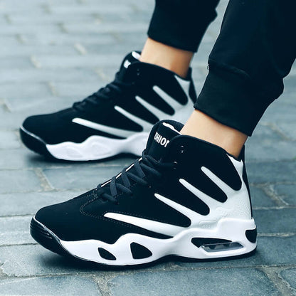 Black and white sneakers worn on a stone pavement