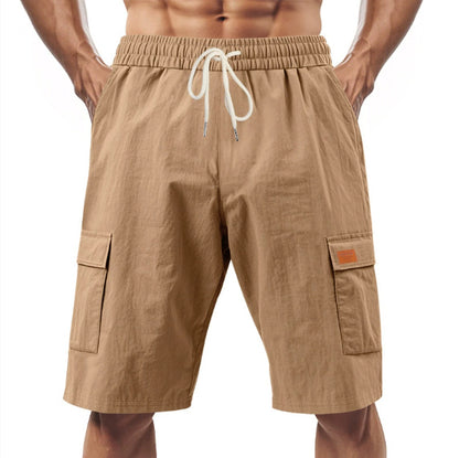 Beige cargo shorts with a drawstring on a white background