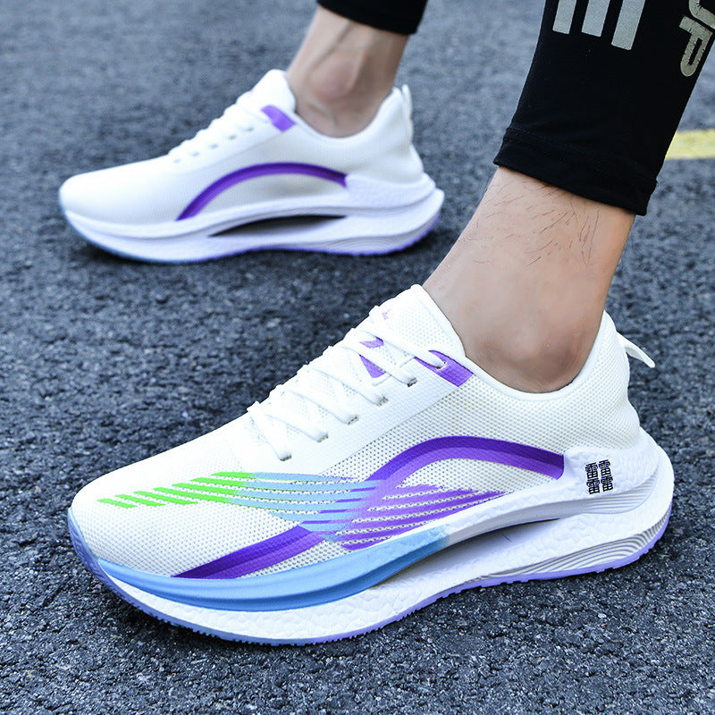 White running shoes with purple and green accents on a textured surface