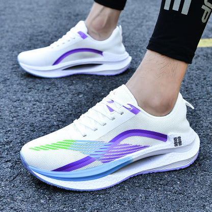 White running shoes with purple and green accents on a textured surface